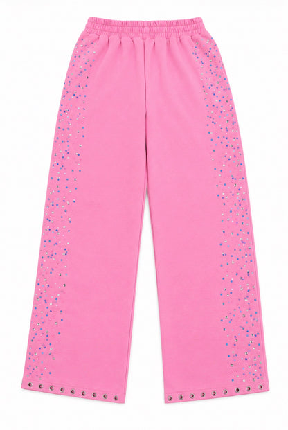 Bright pink wide-leg pants with silver rhinestone embellishments running down the sides and along the hem, shown flat against a white background.