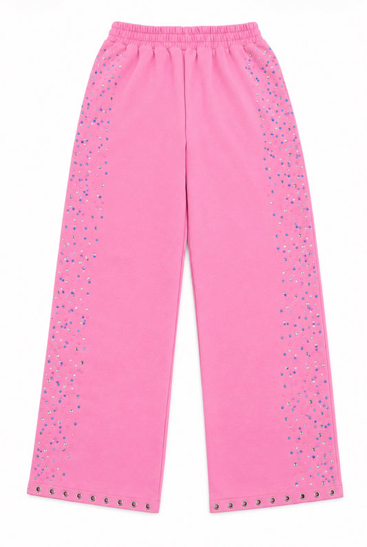 Bright pink wide-leg pants with silver rhinestone embellishments running down the sides and along the hem, shown flat against a white background.